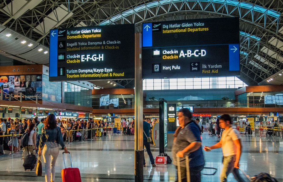 Departure boards showing check-in row letters